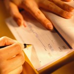 Woman Signing a Check